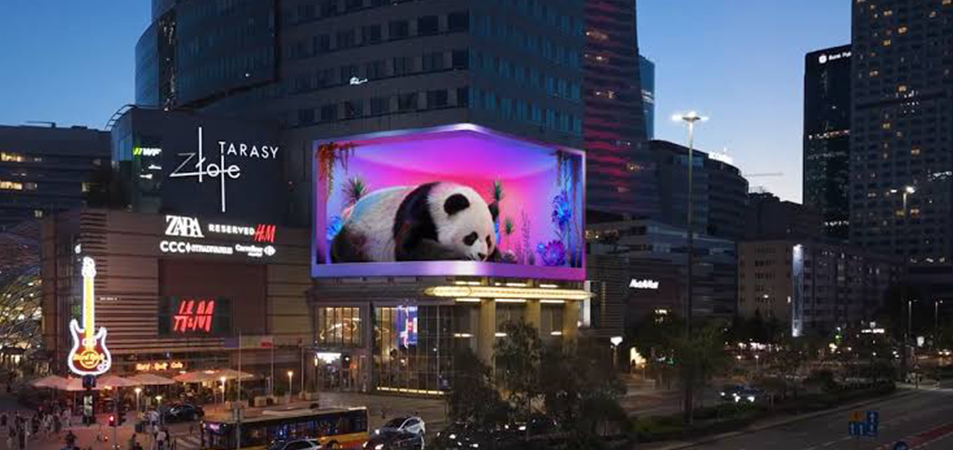 3D billboard1 LED Display Manufacturer in China HonghaiLED Evening city square with a large panda ad on a digital billboard and surrounding shop signs